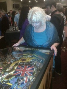 Mary playing pinball after the opening of Tommy -- bringing back memories! 
